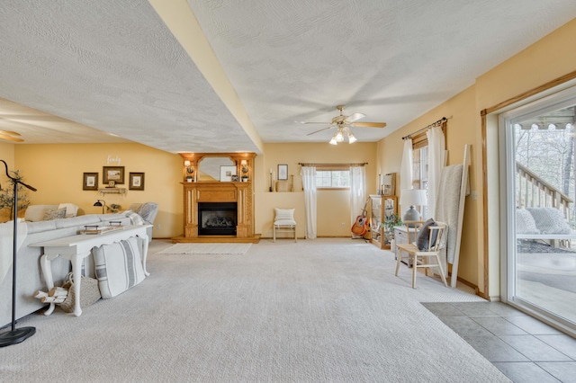 50 Tall Tree Dr, Strafford, MO 65757 - living area with a fireplace, carpet, a textured ceiling, and ceiling fan