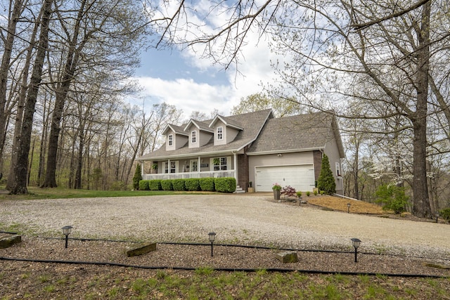 50 Tall Tree Dr, Strafford, MO 65757 - view of front of home with roof with shingles, driveway, a porch, brick siding, and a garage