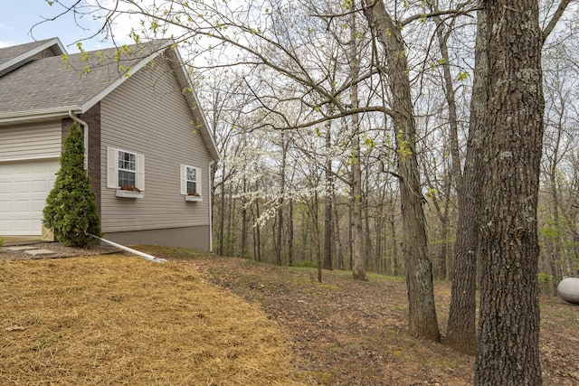 50 Tall Tree Dr, Strafford, MO 65757 - view of side of property featuring a shingled roof and a garage
