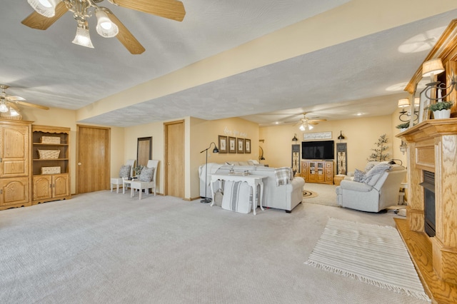 50 Tall Tree Dr, Strafford, MO 65757 - carpeted living room featuring ceiling fan and a glass covered fireplace