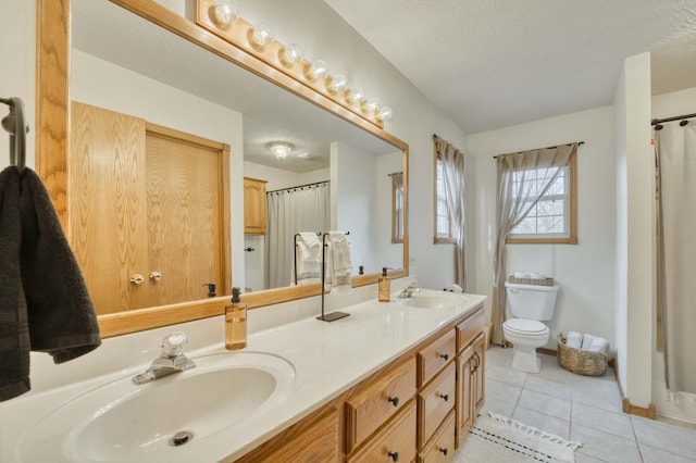 50 Tall Tree Dr, Strafford, MO 65757 - full bathroom with double vanity, tile patterned flooring, toilet, and a sink