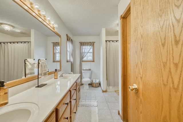 50 Tall Tree Dr, Strafford, MO 65757 - full bath featuring a sink, a textured ceiling, double vanity, toilet, and tile patterned flooring