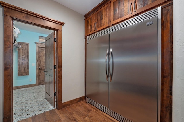 231 Cedar Stone, Ozark, MO 65721 - kitchen with dark wood finished floors, stainless steel built in refrigerator, and baseboards