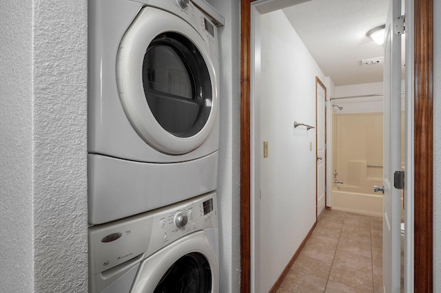 231 Cedar Stone, Ozark, MO 65721 - laundry area featuring baseboards, stacked washing maching and dryer, laundry area, and light tile patterned floors