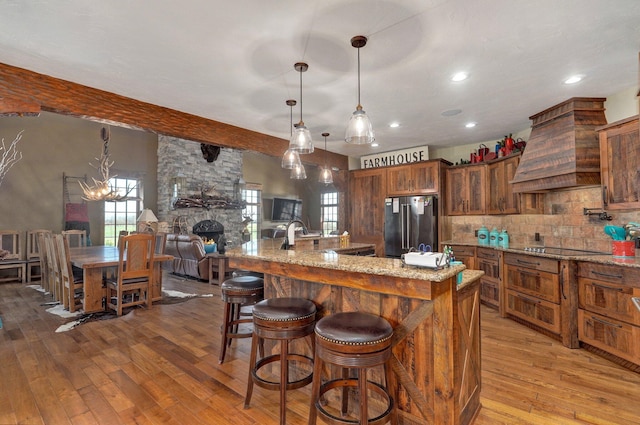 231 Cedar Stone, Ozark, MO 65721 - kitchen with custom exhaust hood, tasteful backsplash, hardwood / wood-style floors, high quality fridge, and beam ceiling