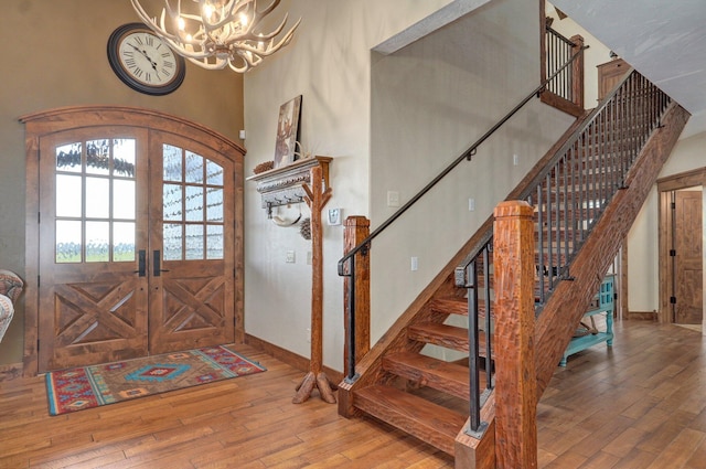 231 Cedar Stone, Ozark, MO 65721 - foyer entrance featuring hardwood / wood-style floors, a high ceiling, stairway, and an inviting chandelier