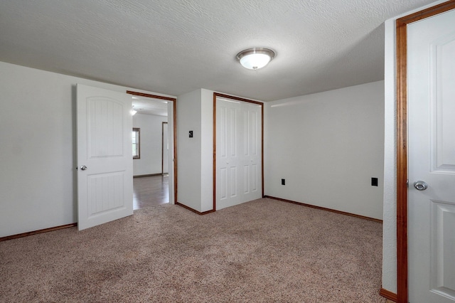 231 Cedar Stone, Ozark, MO 65721 - unfurnished bedroom with baseboards, carpet flooring, a textured ceiling, and a closet