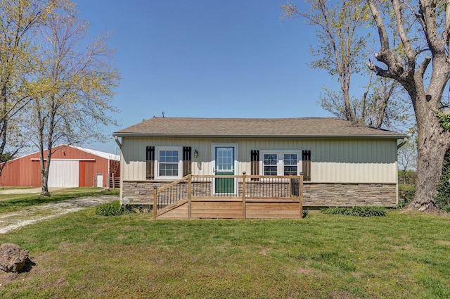231 Cedar Stone, Ozark, MO 65721 - view of front of home with a pole building, a detached garage, stone siding, and a front lawn