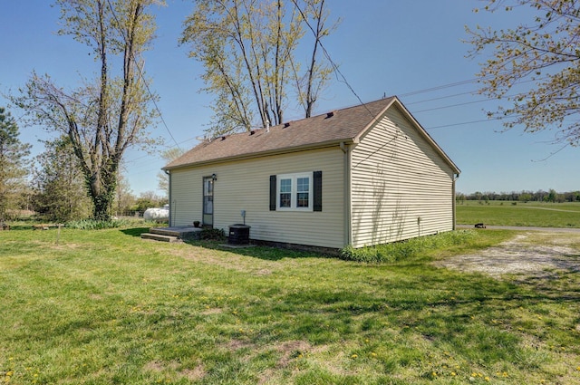231 Cedar Stone, Ozark, MO 65721 - back of property with central AC unit, roof with shingles, and a yard