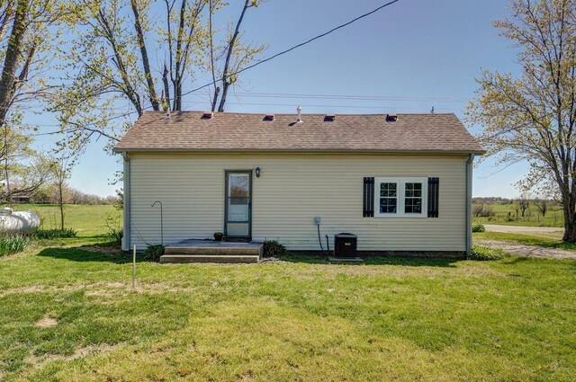 231 Cedar Stone, Ozark, MO 65721 - rear view of property with roof with shingles, a yard, and central AC