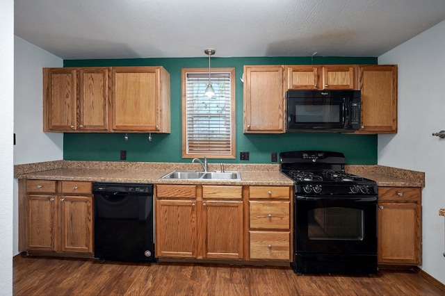 231 Cedar Stone, Ozark, MO 65721 - kitchen featuring a sink, brown cabinetry, black appliances, decorative light fixtures, and dark wood-style flooring