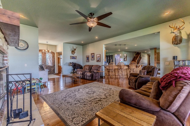 19800 Providence Dr, Lebanon, MO 65536 - living area with a fireplace, wood finished floors, and ceiling fan with notable chandelier