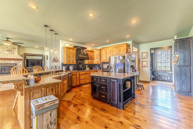 19800 Providence Dr, Lebanon, MO 65536 - kitchen with a ceiling fan, appliances with stainless steel finishes, a sink, and light wood finished floors