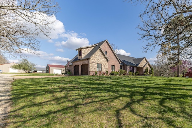 19800 Providence Dr, Lebanon, MO 65536 - view of side of home featuring stone siding, a lawn, and brick siding