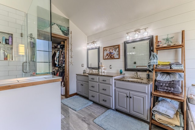 19800 Providence Dr, Lebanon, MO 65536 - bathroom featuring a shower stall, vaulted ceiling, vanity, and a spacious closet