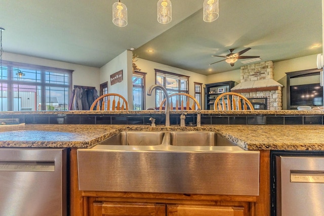 19800 Providence Dr, Lebanon, MO 65536 - kitchen featuring open floor plan, stainless steel dishwasher, a sink, and a ceiling fan