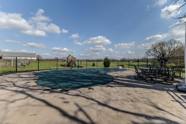 19800 Providence Dr, Lebanon, MO 65536 - view of swimming pool featuring fence, a patio area, a fenced in pool, and a playground