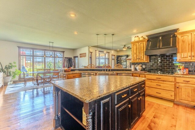 19800 Providence Dr, Lebanon, MO 65536 - kitchen with open shelves, backsplash, a sink, light wood-style floors, and a kitchen island