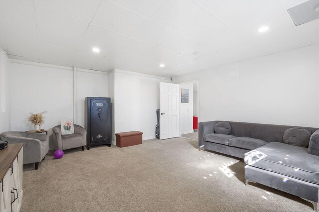 living area with recessed lighting, light colored carpet, and a drop ceiling