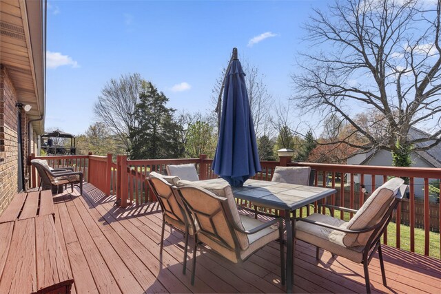 wooden terrace featuring outdoor dining area