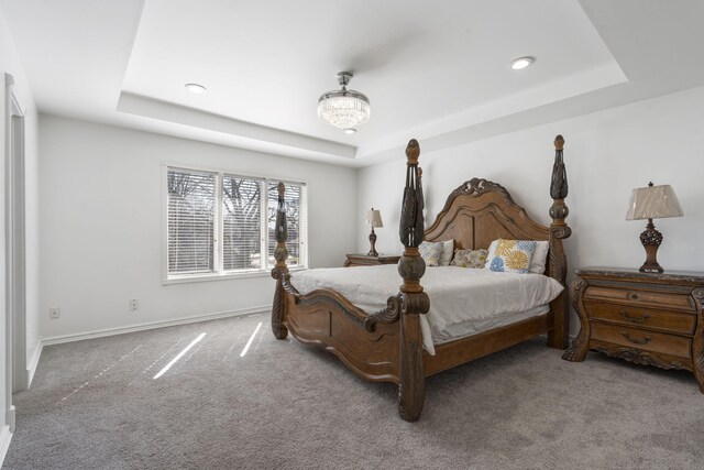 bedroom featuring a tray ceiling, carpet flooring, baseboards, and recessed lighting