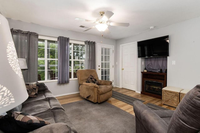 720 Fall Creek Dr Unit 3, Branson, MO 65616 - living room with baseboards, wood finished floors, a fireplace, and a ceiling fan
