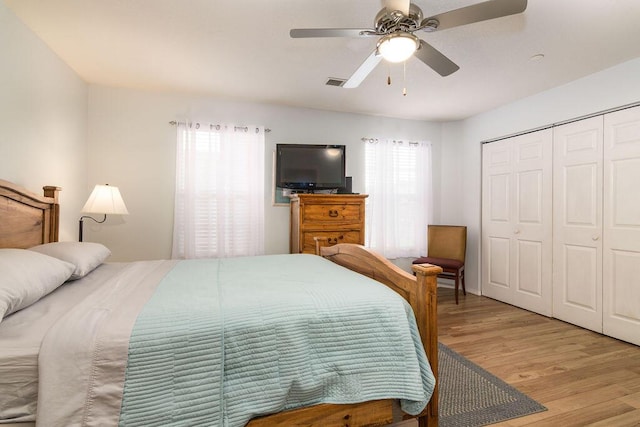 720 Fall Creek Dr Unit 3, Branson, MO 65616 - bedroom featuring multiple windows, light wood-style flooring, a closet, and ceiling fan