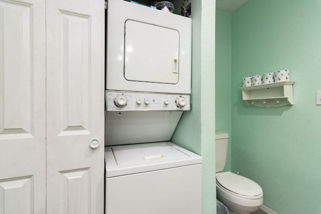 720 Fall Creek Dr Unit 3, Branson, MO 65616 - bathroom featuring stacked washing machine and dryer and toilet
