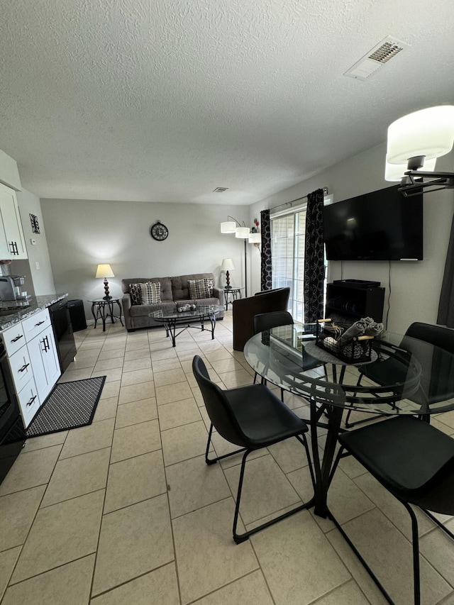 27 Fall Creek Dr, Branson, MO 65616 - dining space featuring a textured ceiling and light tile patterned floors