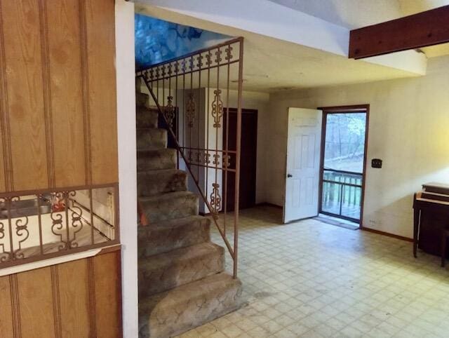 stairs with baseboards and tile patterned floors