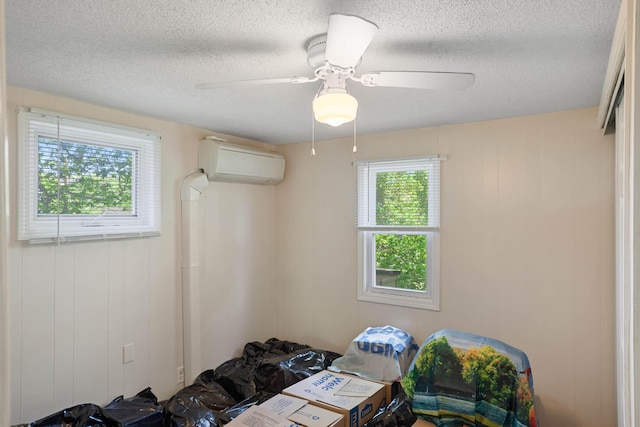 295 Glendale St, Rockaway Beach, MO 65740 - unfurnished bedroom with a textured ceiling, a ceiling fan, and a wall mounted AC