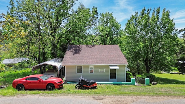 295 Glendale St, Rockaway Beach, MO 65740 - view of front of house featuring a carport and a front lawn