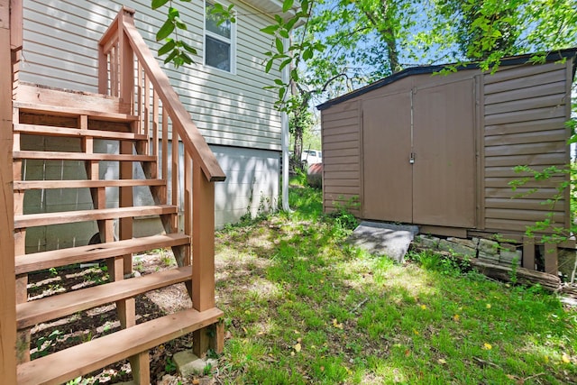295 Glendale St, Rockaway Beach, MO 65740 - view of yard featuring a storage unit, an outdoor structure, and stairway