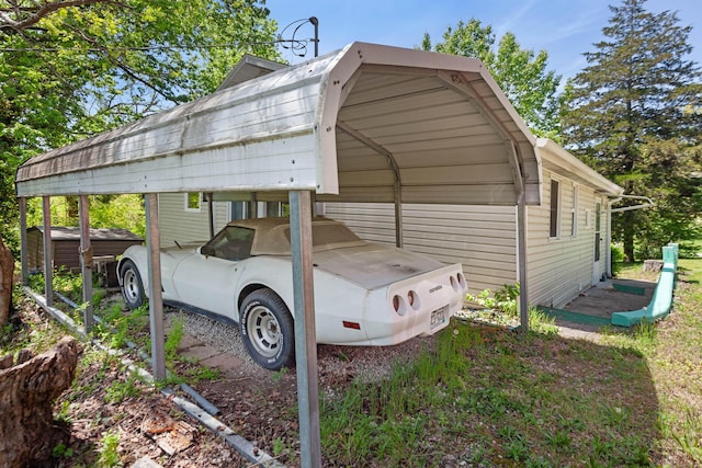 295 Glendale St, Rockaway Beach, MO 65740 - view of parking featuring a detached carport and a storage shed