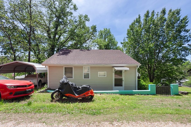 295 Glendale St, Rockaway Beach, MO 65740 - rear view of house with a carport, a yard, and roof with shingles