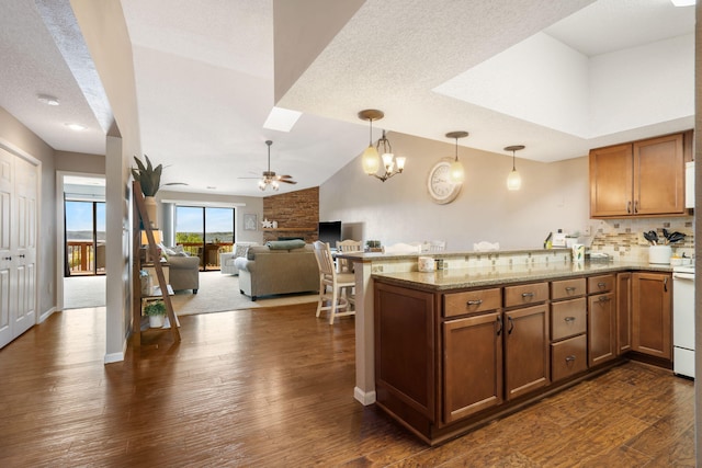 67 Port Dr Unit 7, Kimberling City, MO 65686 - kitchen featuring a ceiling fan, a peninsula, dark wood-style flooring, and brown cabinets