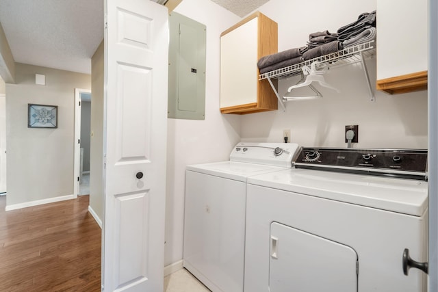 67 Port Dr Unit 7, Kimberling City, MO 65686 - laundry room with light wood-style flooring, washing machine and dryer, electric panel, baseboards, and cabinet space