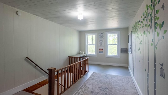 staircase featuring baseboards and wood finished floors
