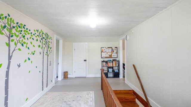 hall with baseboards and an upstairs landing