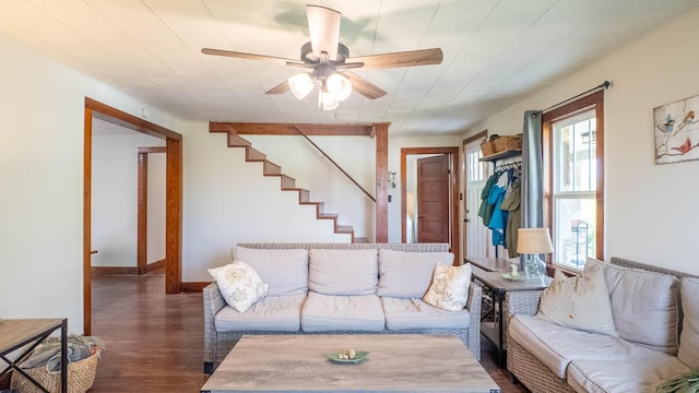 living room with baseboards, wood finished floors, a ceiling fan, and stairs