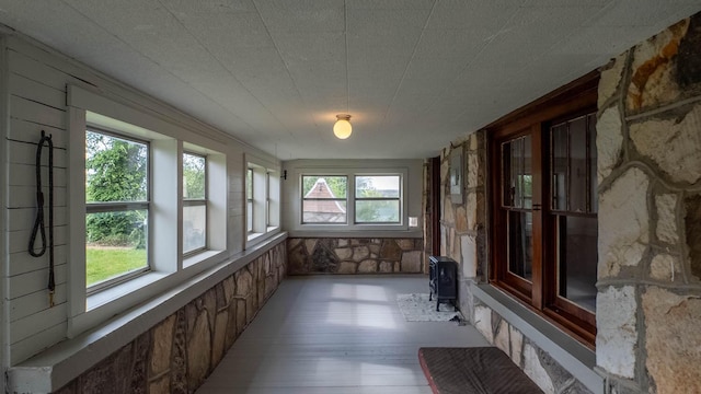 unfurnished sunroom featuring wood finished floors