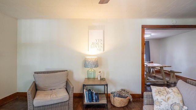 living area with wood finished floors and baseboards