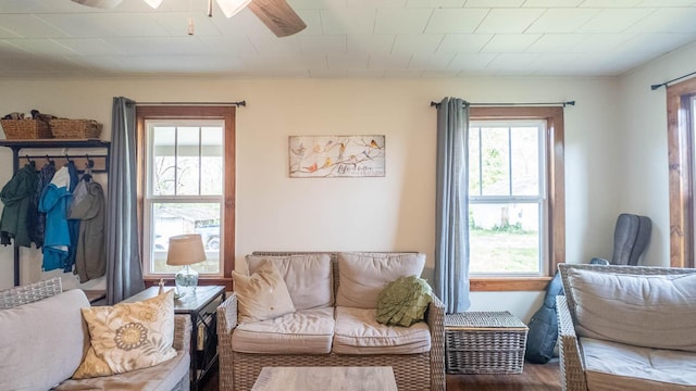 sitting room with wood finished floors and ceiling fan