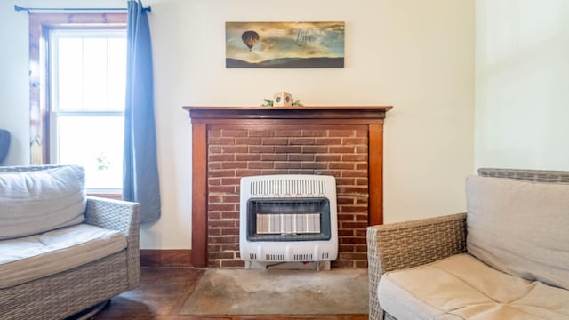 sitting room featuring heating unit and a fireplace