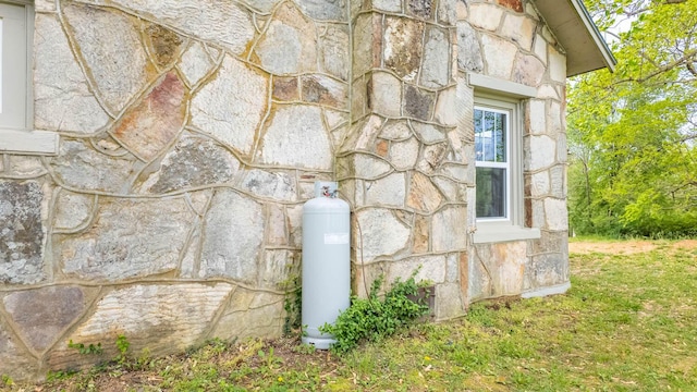 details featuring heating fuel and stone siding