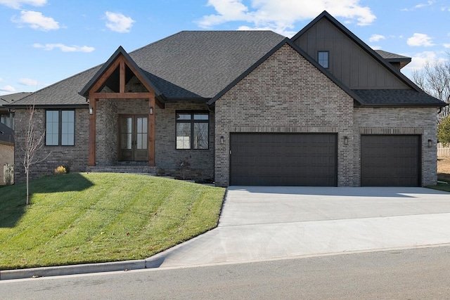 5913 S Clay Ave, Springfield, MO 65810 - view of front of home featuring a front yard, driveway, board and batten siding, and brick siding