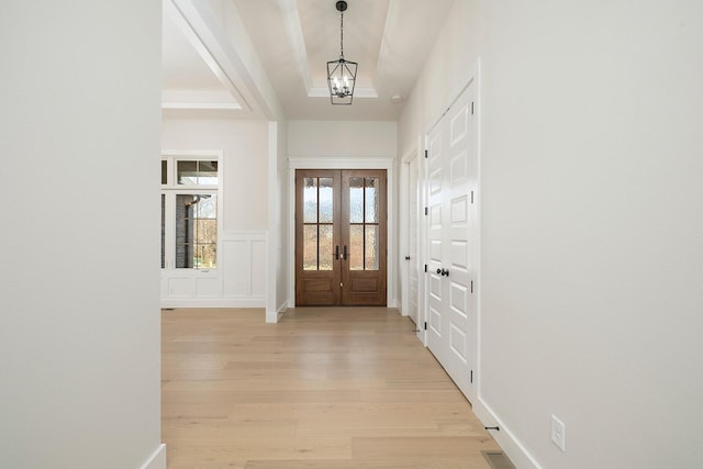 5913 S Clay Ave, Springfield, MO 65810 - entrance foyer with a tray ceiling, a notable chandelier, french doors, and light wood-style floors