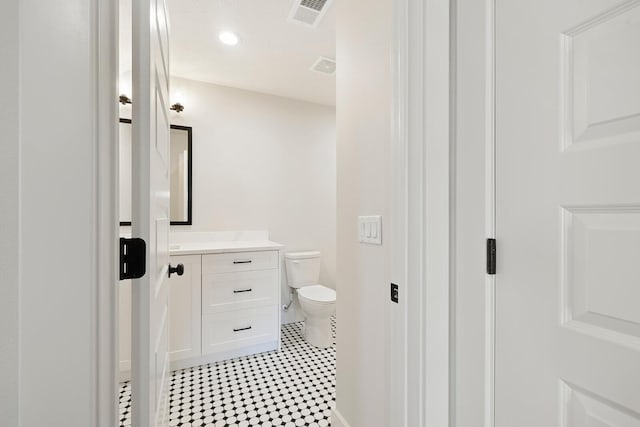 5913 S Clay Ave, Springfield, MO 65810 - half bathroom featuring visible vents, recessed lighting, toilet, and vanity