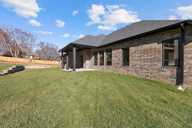 5913 S Clay Ave, Springfield, MO 65810 - rear view of property featuring a lawn, roof with shingles, and brick siding