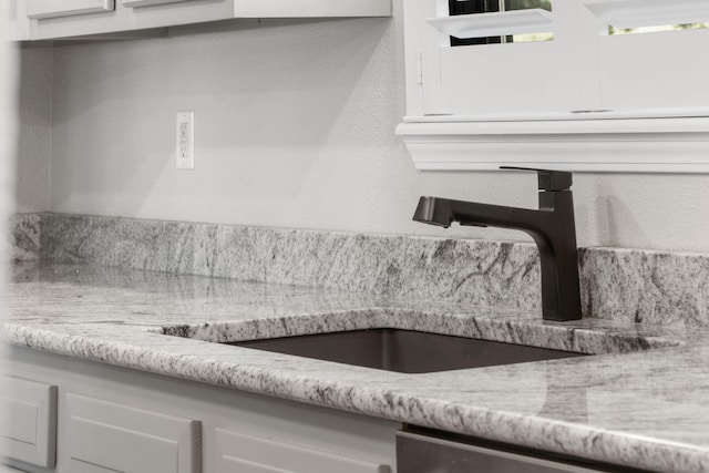 room details featuring stainless steel dishwasher and a sink